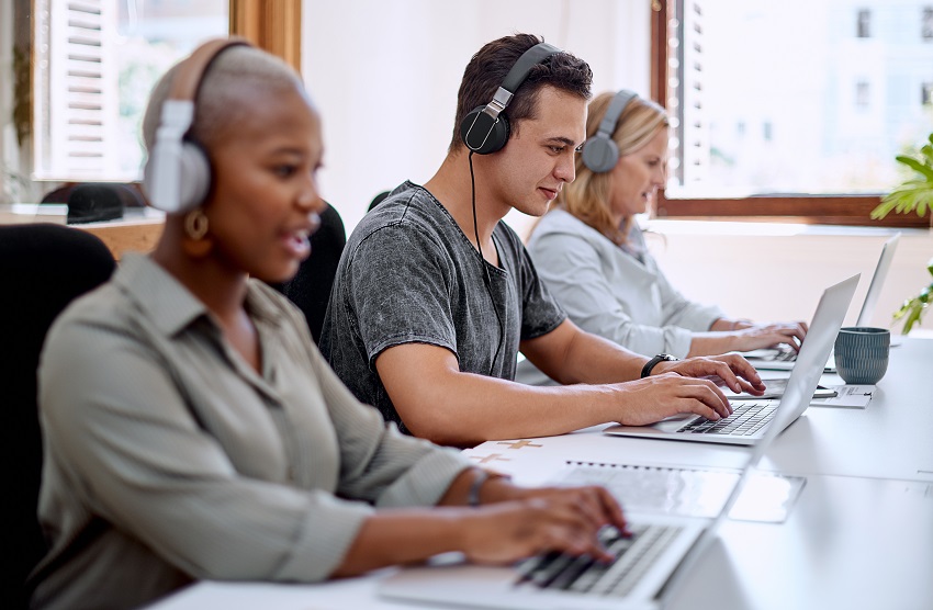 Individuals in a contact centre wearing headsets